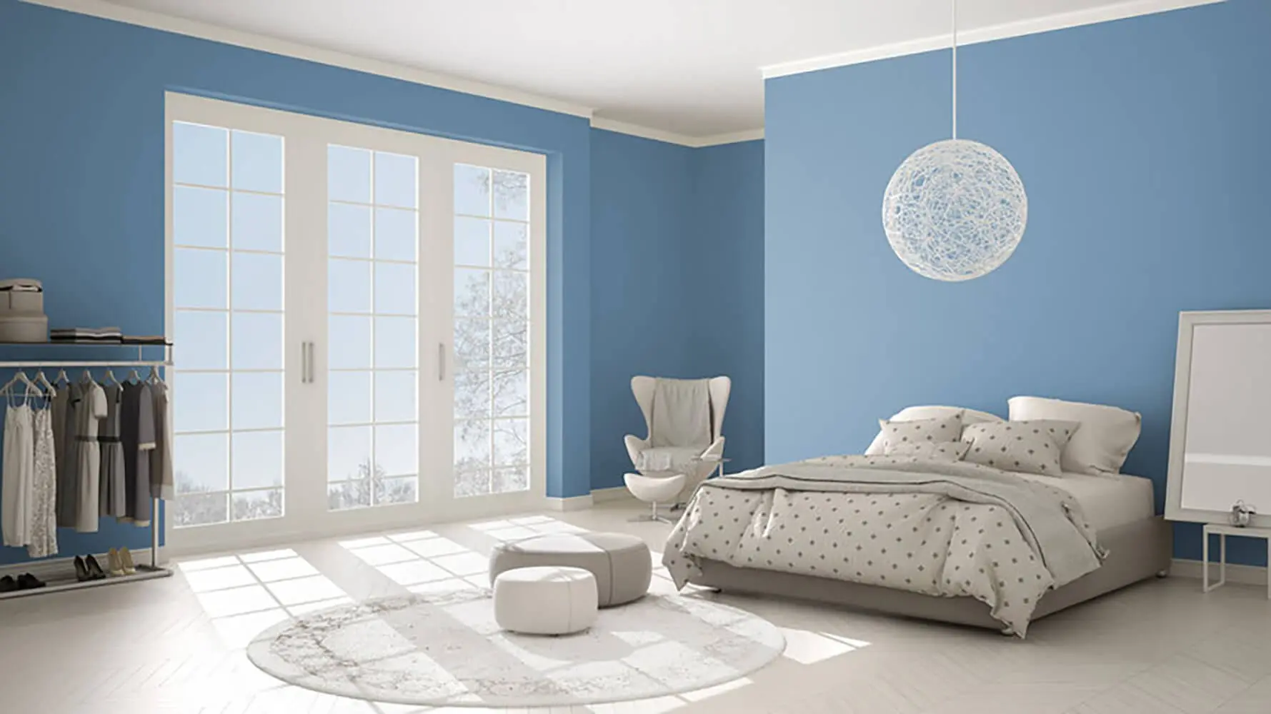 Bright bedroom with soft blue paint walls and white trim showing how paint color affects perceived room size